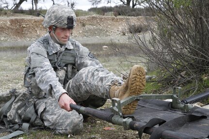 U.S. Army Spc. Jordan Howes of the 2-378th, 91st Training Division opens a litter for the transport of a casualty during a simulated extraction mission on February 8th, 2017 on Ft. Hunter Liggett, Calif. Soldiers competed in the 91st Training Division's Best Warrior Competition that tested their endurance and knowledge of warrior tasks and drills. (U.S. Army photo by Spc. Derek Cummings/Released)