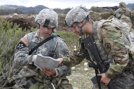 U.S. Army Sgt. Zachary Greene (left) and Sgt. Juan Padilla (right) go over coordinates for the evacuation of a casualty during a simulated extraction mission on February 8th, 2017 on Ft. Hunter Liggett, Calif. Soldiers competed in the 91st Training Division's Best Warrior Competition that tested their endurance and knowledge of warrior tasks and drills. (U.S. Army photo by Spc. Derek Cummings/Released)