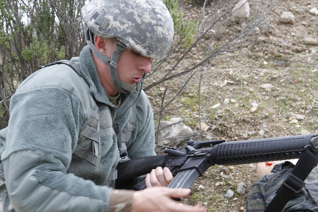 U.S. Army Pfc. Max Lanzing of the 75th Training Division reloads his weapon during a simulated extraction mission on February 8th, 2017 on Ft. Hunter Liggett, Calif. Soldiers competed in the 91st Training Division's Best Warrior Competition that tested their endurance and knowledge of warrior tasks and drills. (U.S. Army photo by Spc. Derek Cummings/Released)