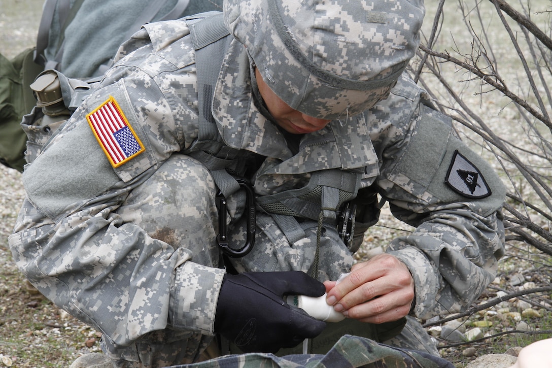 U.S. Army Sgt. Kinoroy Quilaton of the 91st Training Division provides care for a casualty during a simulated extraction mission on February 8th, 2017 on Ft. Hunter Liggett, Calif. Soldiers competed in the 91st Training Division's Best Warrior Competition that tested their endurance and knowledge of warrior tasks and drills. (U.S. Army photo by Spc. Derek Cummings/Released)