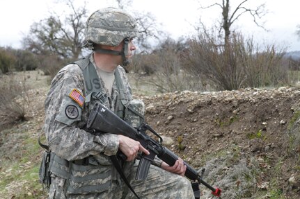 U.S. Army Staff Sgt. Zachary Morin of the 2nd Brigade, 75th Training Division scans the treeline during a simulated extraction mission on February 8th, 2017 on Ft. Hunter Liggett, Calif. Soldiers competed in the 91st Training Division's Best Warrior Competition that tested their endurance and knowledge of warrior tasks and drills. (U.S. Army photo by Spc. Derek Cummings/Released)