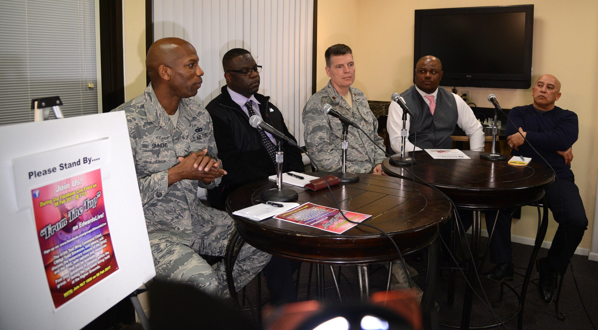 Chief Master Sergeant Todd Simmons (left), 412th Test Wing command chief, uses social media to be sure his voice is hear far and wide Feb. 8 during a Facebook Live broadcast titled “From the Top” from the Higher Grounds internet café in the dormitory complex.
Edwards top enlisted leader was joined by a panel of experts – Damion Hart, 412th Force Support Squadron food service officer; Chaplain (Maj.) John Von Almen, 412th Test Wing; Quintin Pollard, personal finance manager with the 412th FSS;   and Robin Nobriga, chief of quality assurance with the 412th Comptroller Squadron – share their knowledge with Edwards Airmen to help mitigate the effects of the closure of Edwards’ Dining Facility. The facility is scheduled to close for approximately three months for renovation.
According to the chief, there will be more Facebook Live events in the future, as this is a very effective and far-reaching way to communicate. Edwards is one of the few Air Force bases to use Facebook Live as part of its communication strategy. This was the first time Edwards has used Facebook Live as a town hall style format.
