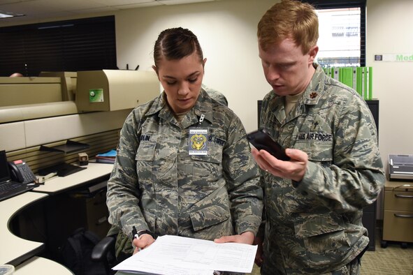 Chaplain (Maj.) Matthew Ellis, 349th Air Mobility Wing chaplain, and Staff Sgt. Lauren Handlin, 349th Aeromedical Staging Squadron medical technician, review the schedule for Patriot Wyvern transportation of infectious disease scenario at Travis Air Force Base, Calif., Feb. 11, 2017. Ellis embedded with ASTS as they transported simulated tuberculosis patients. (U.S. Air Force photo by Senior Airman Sam Salopek)