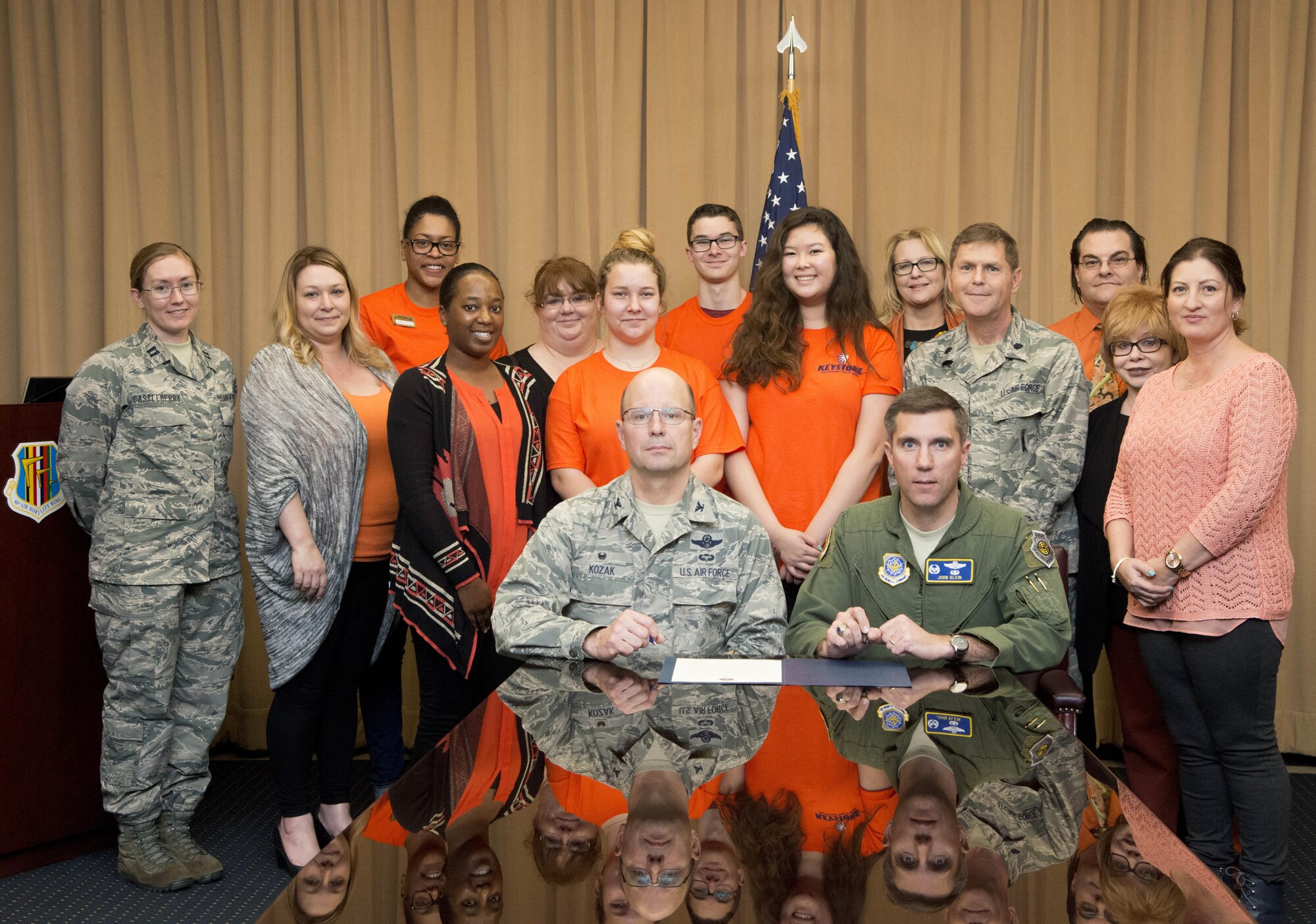 Col. John M. Klein Jr., 60th Air Mobility Wing commander, and Col. Raymond Kozak, 349th Air Mobility Wing commander, pose with the 60th Medical Operations Squadron Family Advocacy team after signing the Teen Dating Violence Awareness Month Proclamation Feb. 9, 2017 at Travis Air Force Base, Calif. (U.S. Air Force photo/Staff Sgt. Nicole Leidholm)