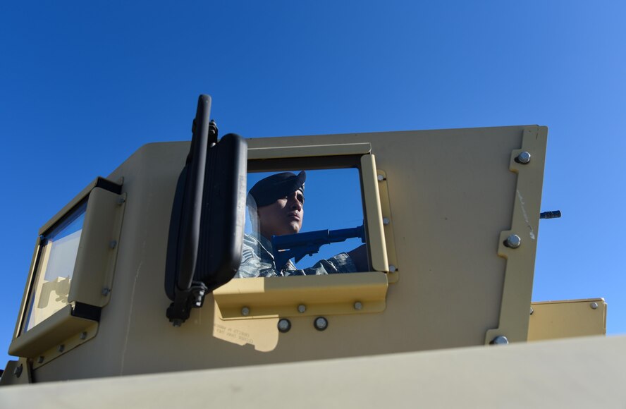 Staff Sgt. Angel Aroche, 349th Security Forces Squadron, mans the Humvee turret gun during convoy training for Patriot Wyvern at Travis Air Force Base, Calif., on Feb. 11, 2017. Security Forces Citizen Airmen encountered simulated improvised explosive devices and malfunctions as they traveled to Conex Village training site.  (U.S. Air Force photo by Senior Airman Sam Salopek)