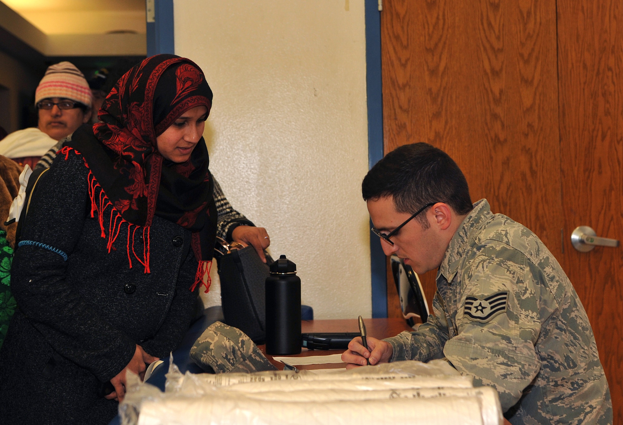 Staff Sgt. Justyn Guthier, 9th Force Support Squadron sports program manager, checks in an evacuee in response to the Oroville spillway evacuation notice at Beale Air Force Base, California, Feb. 12, 2017. Beale provided evacuees with shelter, food, and water. (U.S. Air Force photo/Airman Tristan D. Viglianco)