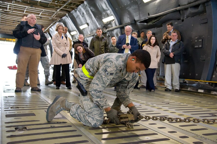 Airman 1st Class Taysean Knight, 436th Aerial Port Squadron cargo handler, attaches a 25,000 pound capacity cargo chain to the floor of a C-5M Super Galaxy Feb. 8, 2017, at Dover Air Force Base, Del. Members of Air Mobility Command’s “Aerial Port of the Future” study team from Scott Air Force Base, Ill., observed Knight and other members of the Super Port demonstrate how ramp services personnel secure a forklift onboard an aircraft. (U.S. Air Force photo by Roland Balik)