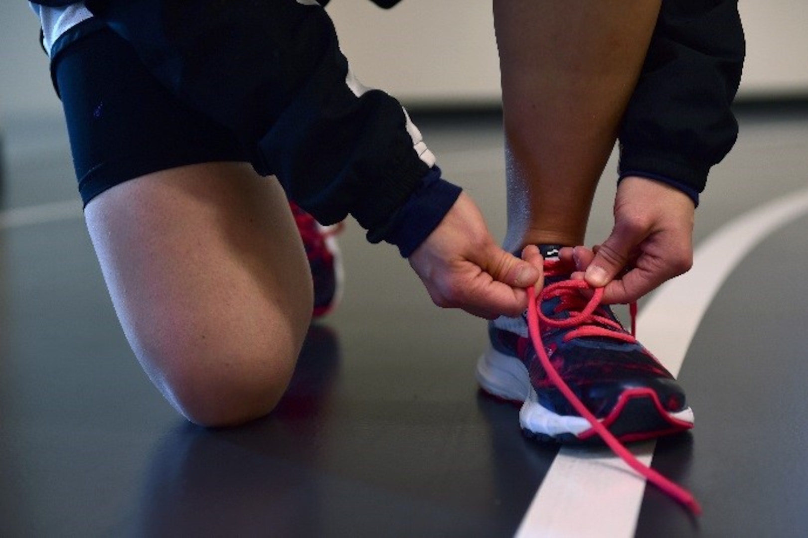 Senior Airman Lacey Kap, 460th Operations Support Squadron space systems operator, laces up her shoes before a workout Dec. 19, 2016, on Buckley Air Force Base, Colo. To stay conditioned, Kap does cardio exercise for an hour-and-a-half five to six times a week. (U.S. Air Force photo by Airman Jacob Deatherage/Released)