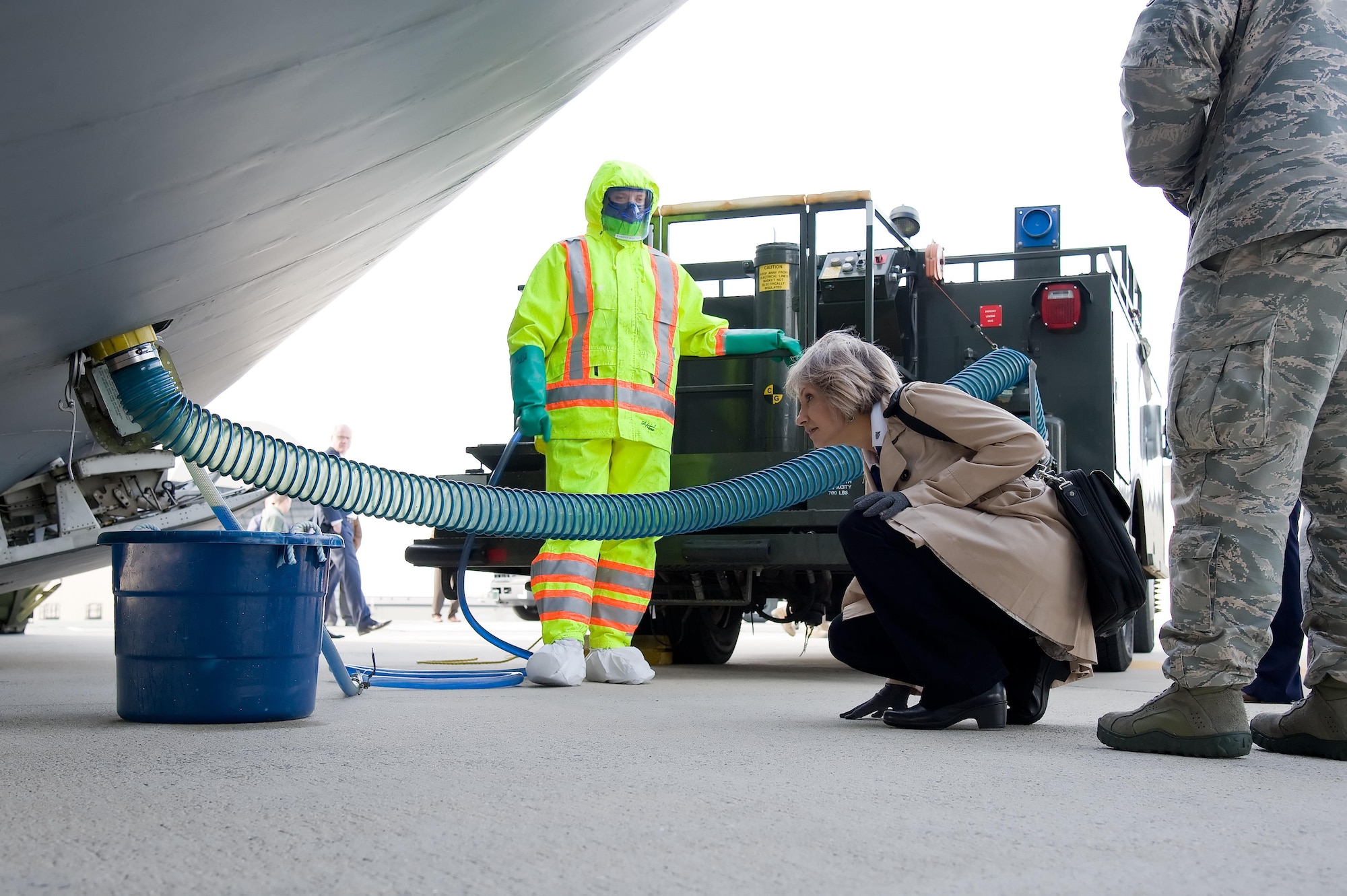 Sara Keller, Logistics, Engineering, Force Protection deputy director, Air Mobility Command, Scott Air Force Base, Ill., looks at the forward lavatory servicing connection of a C-5M Super Galaxy Feb. 8, 2017, at Dover Air Force Base, Del. Wearing protective gear, Airman 1st Class Benjamin Harper, 436th Aerial Port Squadron fleet service specialist, demonstrated for Keller how the lavatory service truck provides waste removal and servicing to C-5Ms, as well as other aircraft. (U.S. Air Force photo by Roland Balik)