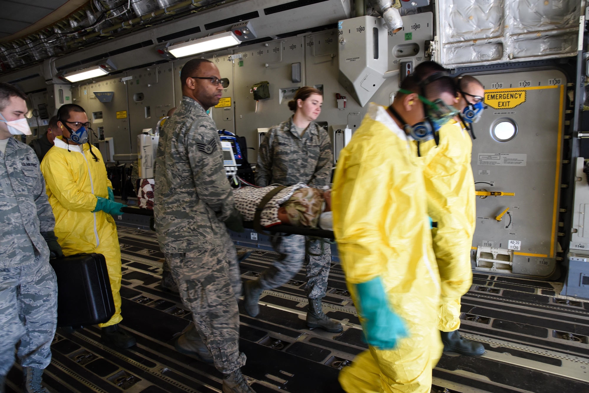 349th Aeromedical Staging Squadron Citizen Airmen litter carry simulated tuberculosis patients during a scenario for exercise Patriot Wyvern at Travis Air Force Base, Calif., Feb. 11, 2017. the 349th ASTS is responsible for the loading and unloading patients from aircraft and administering medical care. (U.S. Air Force photo by Senior Airman Sam Salopek)