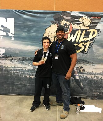 SCHRIEVER AIR FORCE BASE, Colo.-- Jadon Janaros displays his first-place medal with Morris Thomas following the Wild West Nationals wrestling competition in Gillette, Wyoming, Feb. 4, 2017. Janaros also earned Rookie All-American honors in the 13-15 rookie, 130-pound division. Thomas, a staff sergeant with the 50th Space Wing Safety office, has coached approximately 25 Schriever dependents since forming the Children of Valor wrestling club at Schriever Air Force Base, Colorado, in late 2015. (Courtesy photo/Morris Thomas)