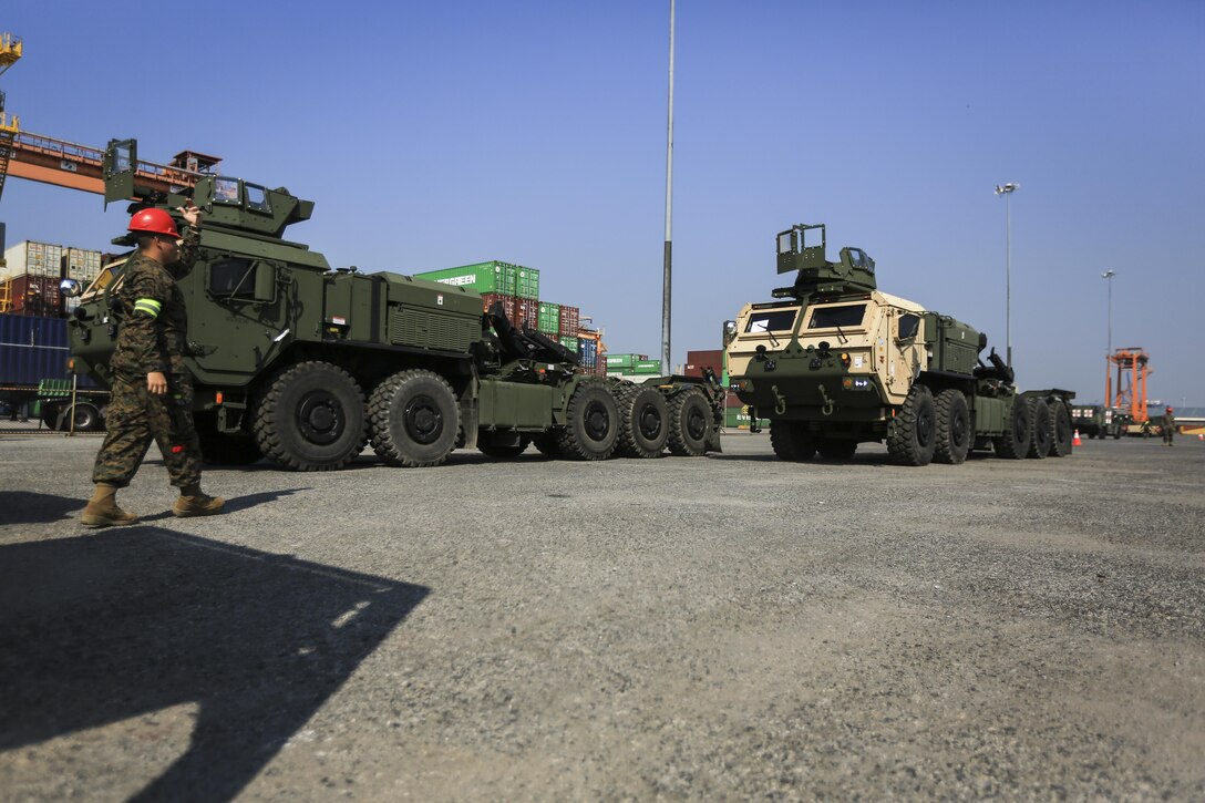 U.S. Marine Corps Lance Cpl. Christian Garajas, a landing support specialist with Combat Logistics Battalion 4, guides a Logistics Vehicle System from the USNS Gunnery Sgt. Fred W. Stockham, during exercise Cobra Gold, at Laem Chabang International Terminal, Thailand, Feb. 11, 2017. Cobra Gold, in its 36th iteration, is an important element of the United States' and all other participating nations' regional military to military engagement efforts. (U.S. Marine Corps photo by Cpl. Wesley Timm)