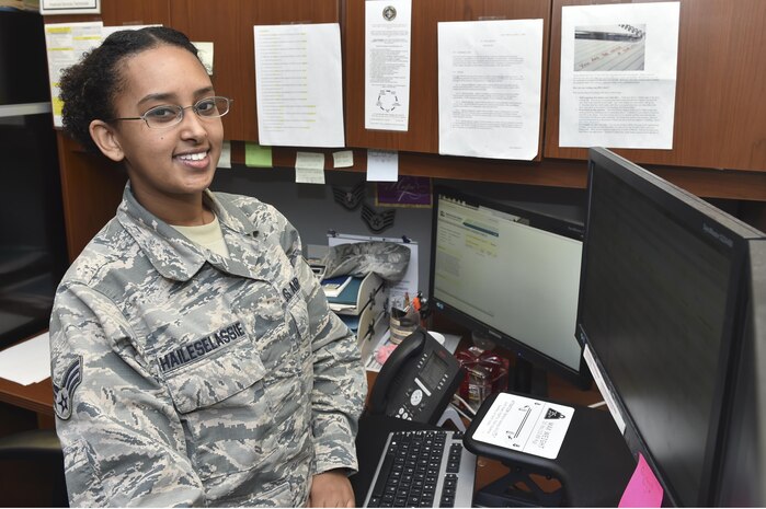 Senior Airman Menebere Haileselassie, 628th Comptroller Squadron financial management technician, poses at her desk Feb. 3, 2017, at Joint Base Charleston, South Carolina. Haileselassie was born in Ethiopia and sent to the U.S. by her parents with her older sister at age 11. 