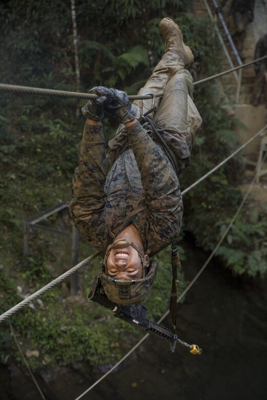 Cpl. Hector R. Marquez, a food service specialist, with Fox Company, Battalion Landing Team, 2nd Battalion, 5th Marines, 31st Marine Expeditionary Unit, participates in the Jungle Warfare Training Center endurance course at, Camp Gonsalves, Okinawa, Japan, Jan. 27, 2017. JWTC exposes Marines to training situations and environments unique to the Indo-Asia-Pacific region which sustain operational readiness and enhance forward deployed capabilities. As the Marine Corps’ only continuously forward deployed unit, the 31st Marine Expeditionary Unit’s air-ground-logistics team provides a flexible force, ready to perform a wide range of military operations, from limited combat to humanitarian assistance operations, throughout the Indo-Asia- Pacific region. (U.S. Marine Corp's photo by Lance Cpl. Breanna L. Weisenberger/Released)