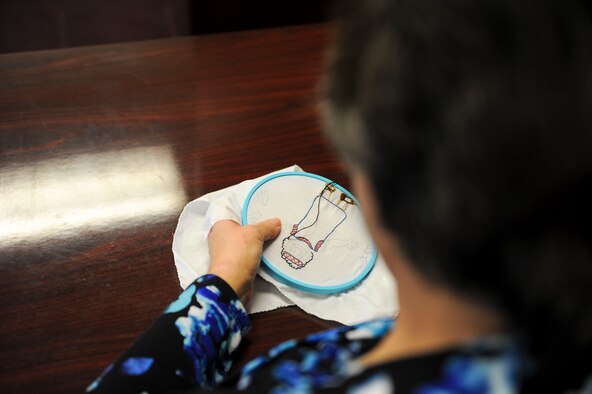 Department of the Air Force employee Kristina Anderson, a 354th Fighter Wing legal office receptionist secretary, embroiders a piece of a quilt Jan. 27, 2017, at Eielson Air Force Base, Alaska. Anderson has been sewing for approximately 45 years and usually spends her lunch breaks sewing gifts for her grandchildren. (U.S. Air Force photo by Airman Isaac Johnson)