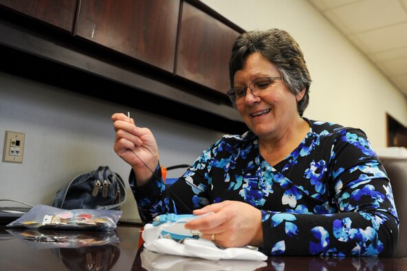 Department of the Air Force employee Kristina Anderson, a 354th Fighter Wing legal office receptionist secretary, works on part of a quilt Jan. 27, 2017, at Eielson Air Force Base, Alaska. As a grandmother of 12, Anderson spends a lot of her down time sewing gifts for her family. (U.S. Air Force photo by Airman Isaac Johnson)