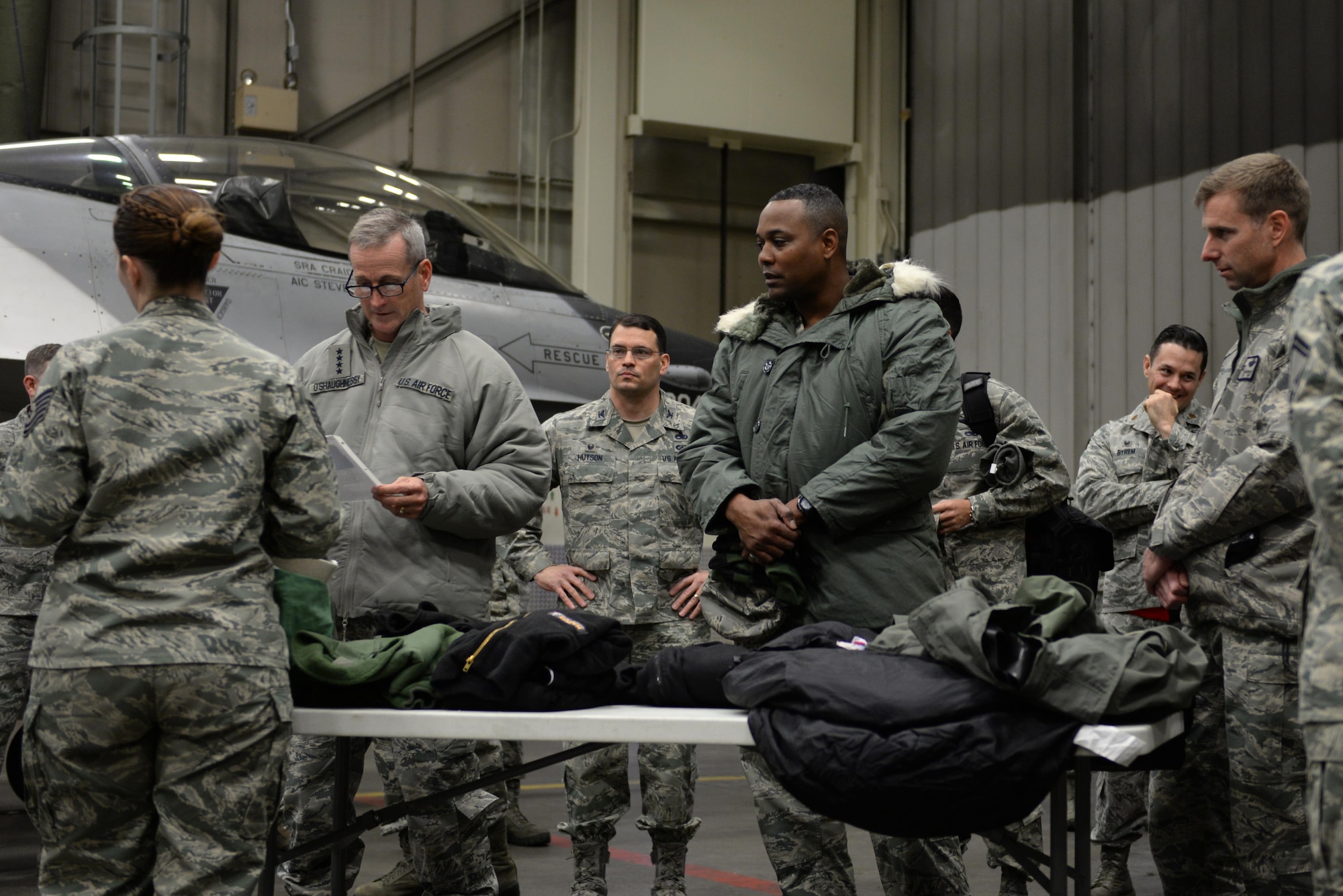 U.S. Air Force Gen. Terrence O’Shaughnessy, Pacific Air Forces commander, and Chief Master Sgt. Anthony Johnson, Pacific Air Forces command chief, receives a briefing about arctic flight suits by Tech. Sgt. Skye Perry, a 354th Operations Support Squadron aircrew flight equipment craftsman, during a base visit at Eielson Air Force Base, Alaska, Feb. 8, 2017. During the visit, O’Shaughnessy and Johnson met with Airmen across the base to gain a firsthand understanding of the unique challenges Alaska’s environment offers and how Icemen thrive and survive. (U.S. Air Force photo by Airman 1st Class Cassandra Whitman)
