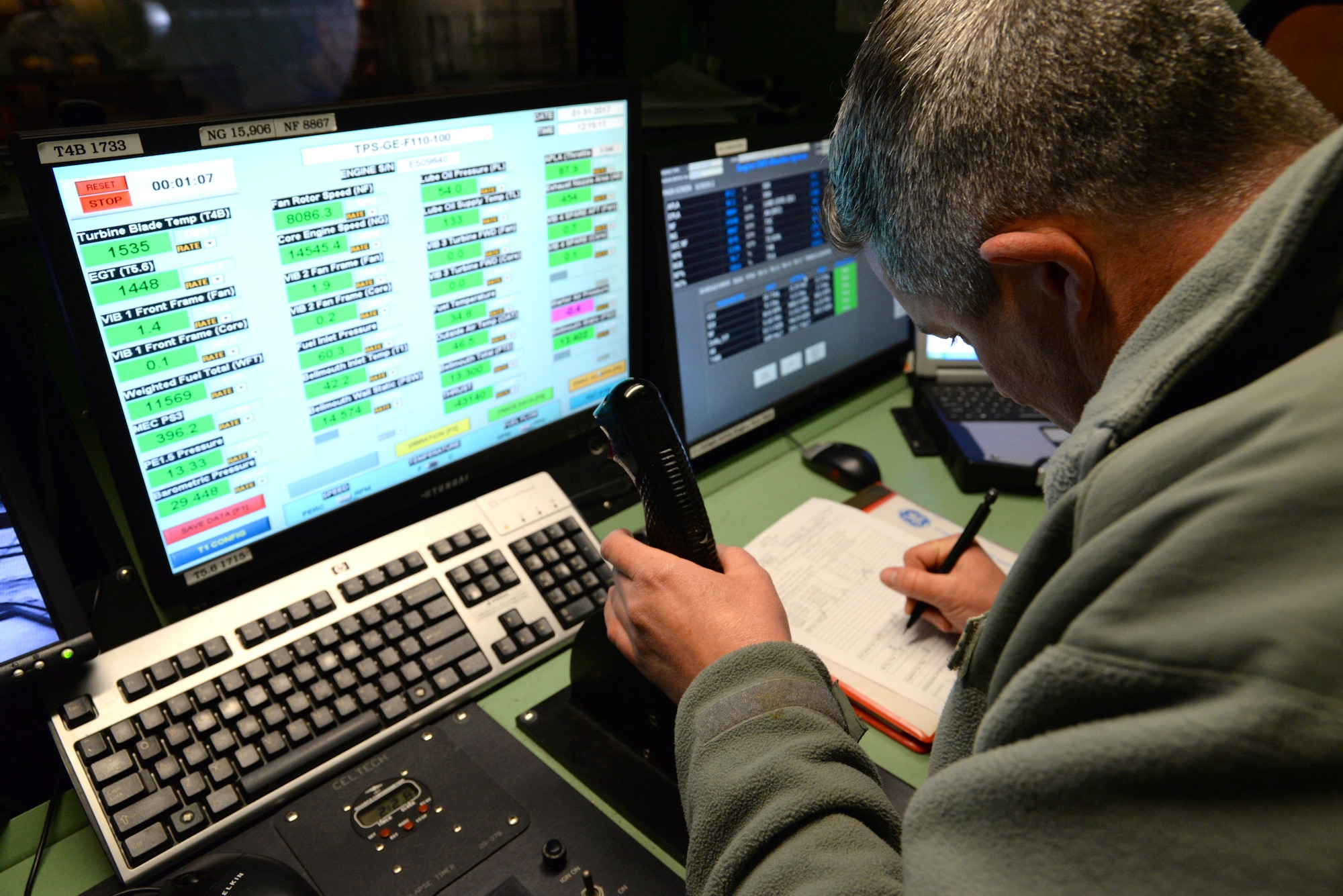 A picture of U.S. Air Force Tech. Sgt. Robert Taylor, propulsion mechanic with the 177th Fighter Wing of the New Jersey Air National Guard, controlling the throttle of an F-16C+ Fighting Falcon engine while noting engine telemetry data during testing.