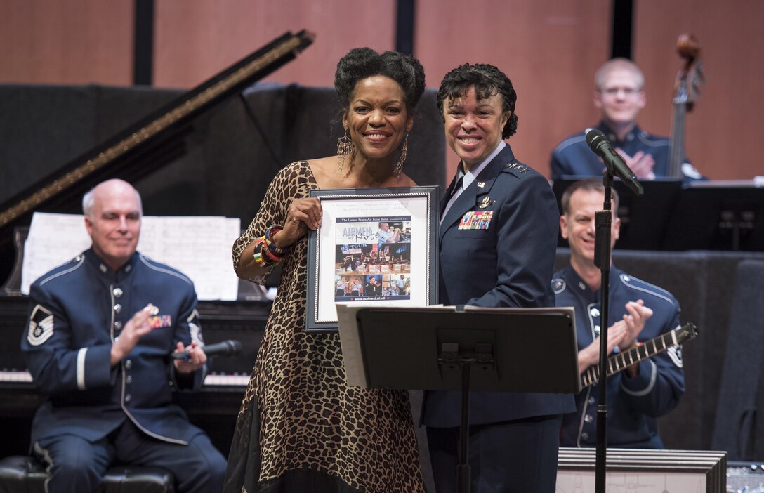 Nnenna Freelon, vocalist, receives a token of appreciation from Lt. Gen. Stayce D. Harris, Headquarters U.S. Air Force assistant vice chief of staff, during a 2017 Jazz Concert Series performance at the Rachel M. Schlesinger Concert Hall and Arts Center in Alexandria, Va., Feb. 9, 2017. Throughout the night’s performance Freelon sang her version of many recognizable jazz tunes, including the Nina Simone song "Feeling Good."  (U.S. Air Force photo by Airman 1st Class Gabrielle Spalding)
