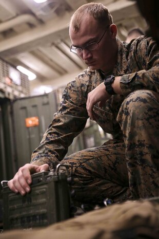 Lance Cpl. Kerry Heinen, an air traffic control communications technician with Marine Air Traffic Control Mobile Team, Marine Medium Tiltrotor Squadron 262, 31st Marine Expeditionary Unit, function checks a PRC-117 radio during a communication equipment maintenance and synchronization exercise (COMEX) aboard the USS Green Bay (LPD 20), Pacific Ocean, Feb. 4, 2017. The COMEX allowed communications specialists and technicians from the air, ground and logistics elements of the 31st MEU to synchronize and repair equipment while establishing communications between the Marine Air-Ground Task Force Elements. The air-ground task force concept is designed to thoroughly exploit the combat power inherent in air and ground assets by closely integrating them into a single force under one commander. The MEU brings what it needs to sustain itself from the sea for the rapid accomplishment of the mission or to pave the way for follow-on forces. (U.S. Marine Corps photo by Sgt. Tiffany Edwards/Released) 