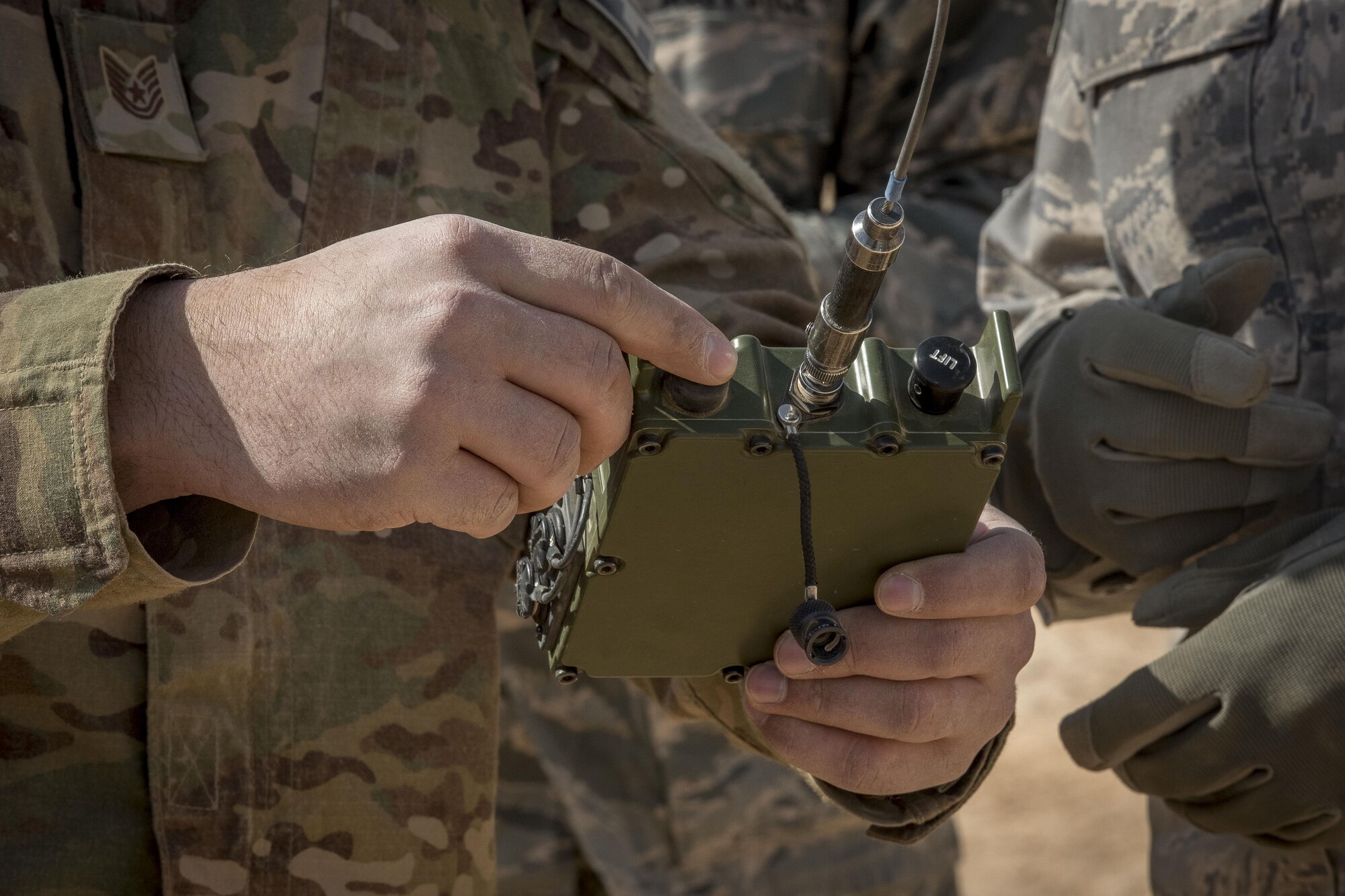 Tech. Sgt. Michael Stuenzi, 332nd Expeditionary Civil Engineer Squadron explosive ordnance disposal technician, explains how to operate a remote firing device transmitter during a range detonation, Feb. 11, 2017, in Southwest Asia. The 332nd ECES EOD Flight facilitated a detonation with the help of U.S. Marine Corps EOD technicians and coalition partners. (U.S. Air Force photo by Staff Sgt. Eboni Reams)