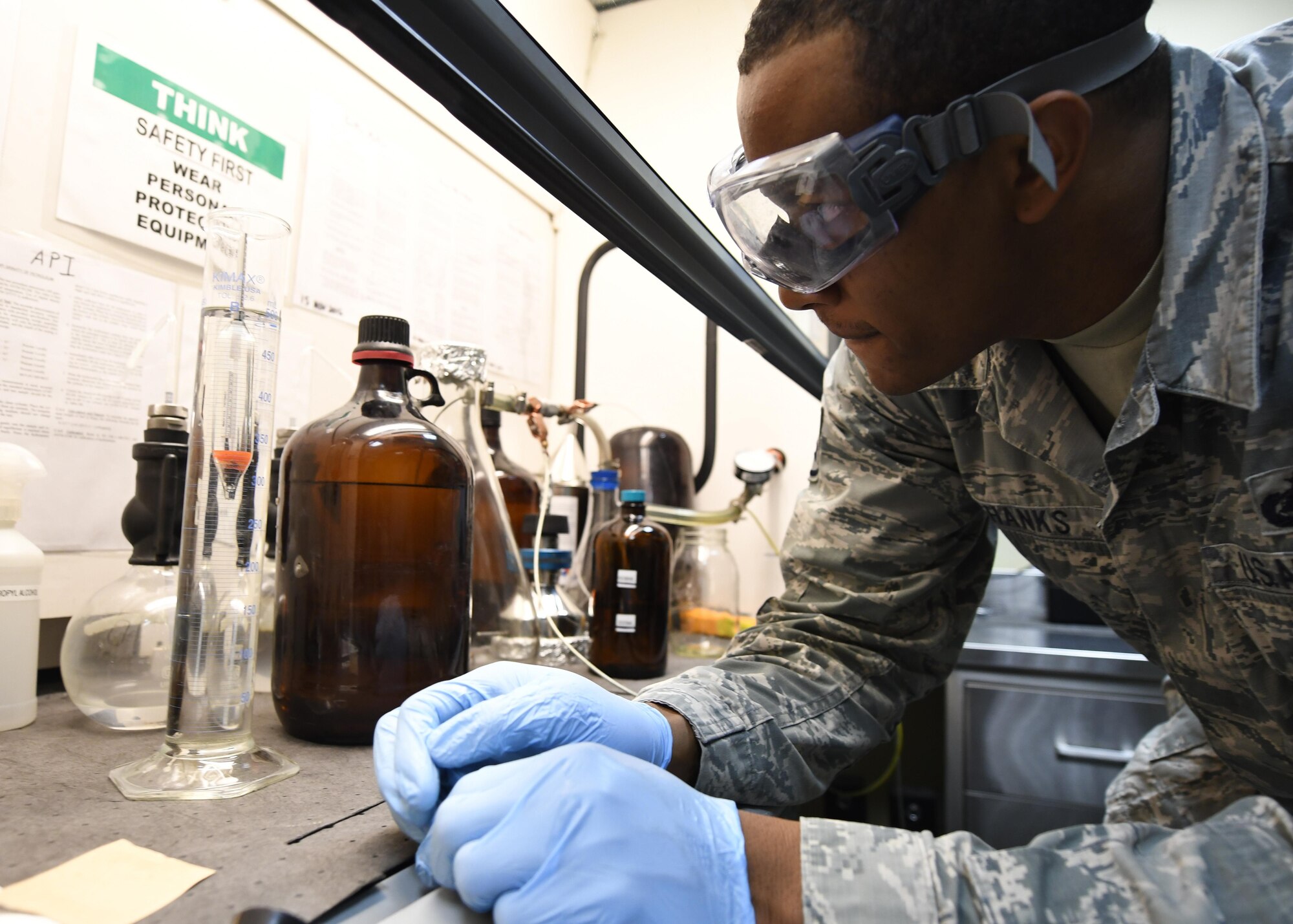 U.S. Air Force Staff Sgt. Mario Shanks, fuels laboratory NCO in charge with the 379th Expeditionary Logistics Readiness Squadron, checks fuel density with a hydrometer at Al Udeid Air Base, Qatar, Feb. 14, 2017. Shanks conducted an American Petroleum Institute specific gravity test on a sample of fuel to determine the density of the fuel which helps them track how much is used.  (U.S. Air Force photo by Senior Airman Miles Wilson)