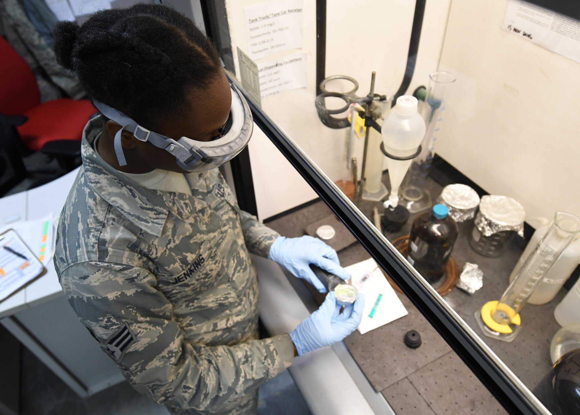 U.S. Air Force Senior Airman Kendra Jenkins, a fuels apprentice with the 379th Expeditionary Logistics Readiness Squadron Fuels Laboratory, checks fuel for additives used to prevent the fuel from freezing at Al Udeid Air Base, Qatar, Feb. 14, 2017. At high altitudes, fuel is susceptible to freezing due to the low temperatures and traces of water that may be inside the fuel. (U.S. Air Force photo by Senior Airman Miles Wilson)
