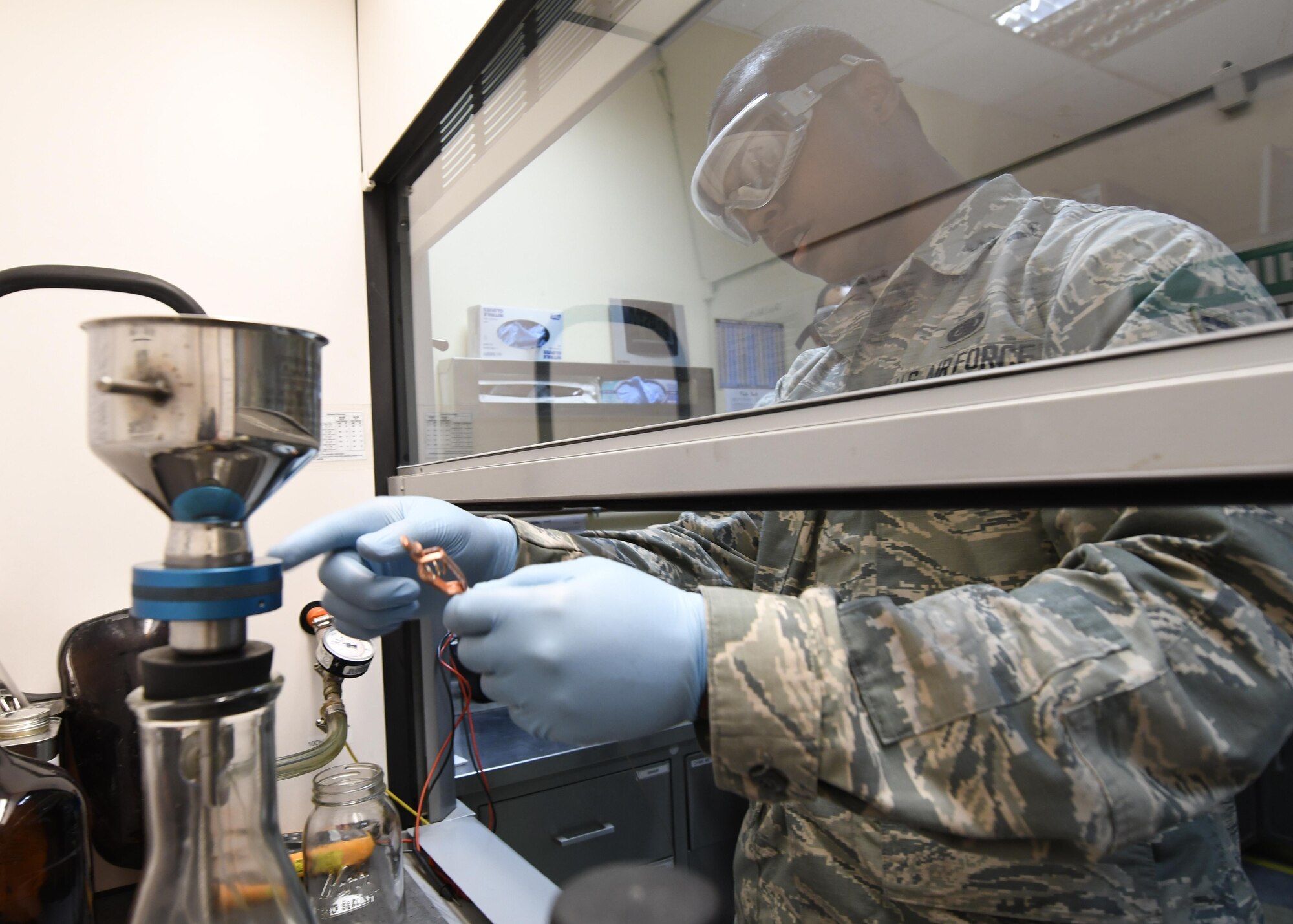 U.S. Air Force Airman 1st Class Jamar Gresham, a fuels apprentice with the 379th Expeditionary Logistics Readiness Squadron Fuels Laboratory, conducts a bottle method test on a sample of fuel at Al Udeid Air Base, Qatar, Feb. 14, 2017. The bottle method test is a way to determine the amount of particulates within fuel by passing it through a filter using a vacuum. (U.S. Air Force photo by Senior Airman Miles Wilson)