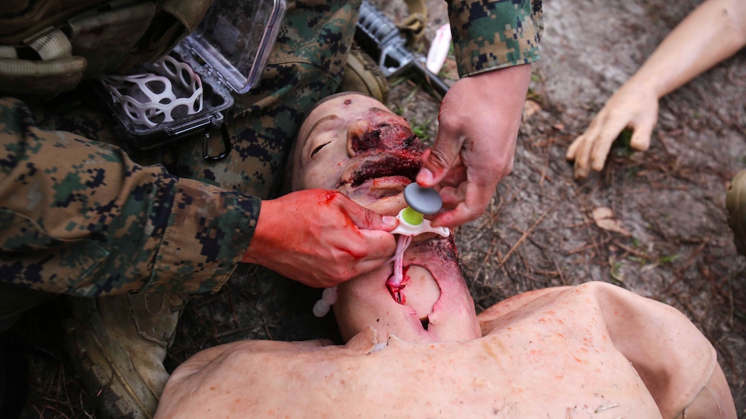 A corpsman inserts a breathing tube into a notional patient during a Tactical Combat Casualty Care training exercise at Marine Corps Base Camp Lejeune, North Carolina, Feb. 6-10, 2017. The TCCC teaches corpsmen new communication skills and how to care for a patient in a combat zone. The corpsmen are with 2nd Medical Battalion. 