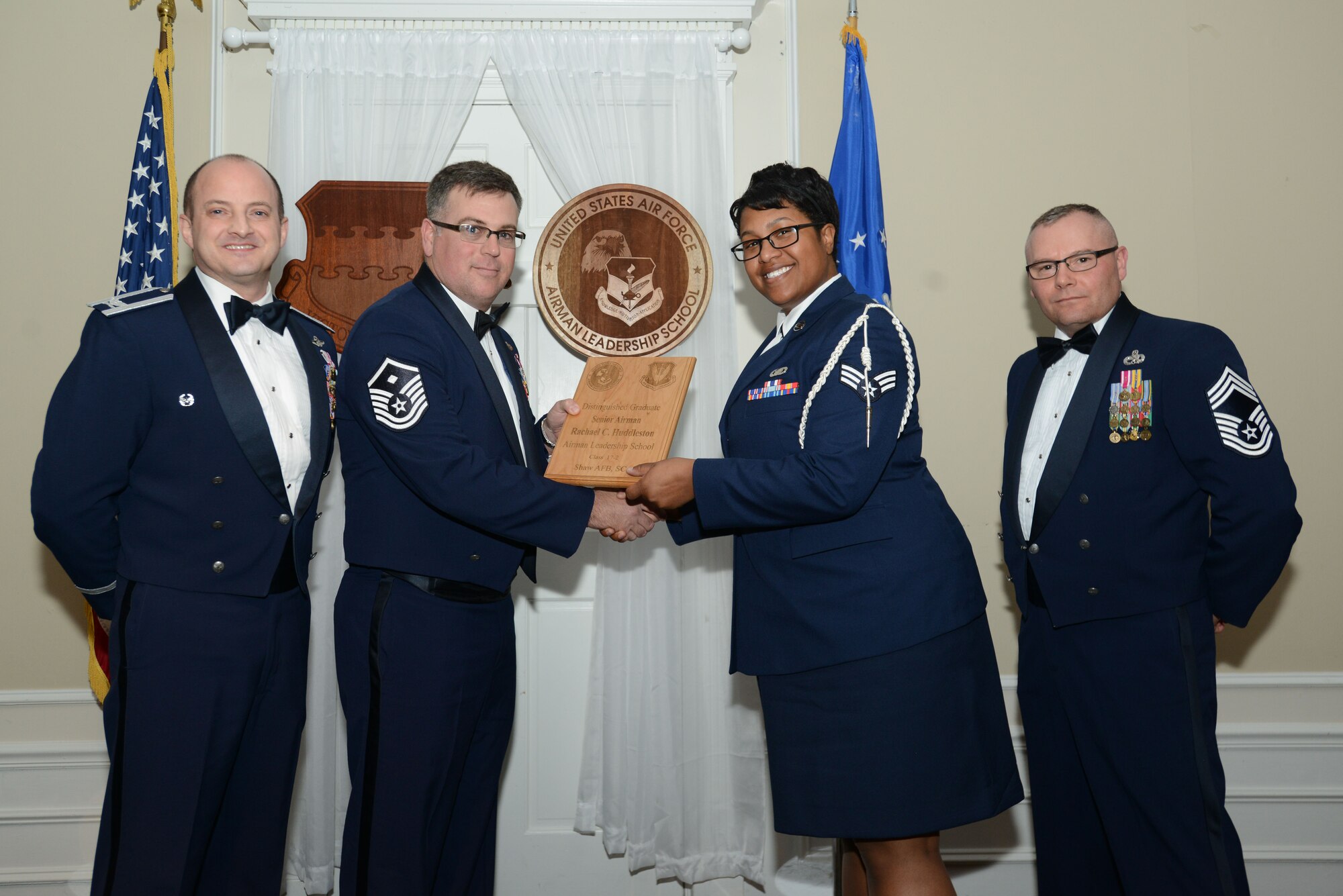 U.S. Air Force Senior Airman Rachael Huddleston, 3rd Intelligence Squadron, receives a distinguished graduate award for the Senior Master Sgt. David B. Reid Airman Leadership School Class 17-2 from Master Sgt. Aaron Bunyea, 609th Air Communications Squadron first sergeant, at Shaw Air Force Base, S.C., Feb. 9, 2017. The distinguished graduate awards are given to the top 10 percent of the class for total point accumulation. (U.S. Air Force photo by Airman 1st Class Kelsey Tucker)