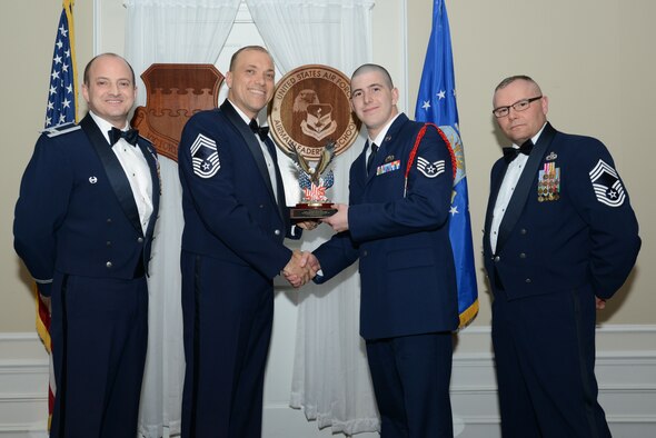 U.S. Air Force Staff Sgt. Daniel Rice, 31st Intelligence Squadron, receives the John L. Levitow Award for the Senior Master Sgt. David B. Reid Airman Leadership School Class 17-2, from Chief Master Sgt. Richard Skrabak, 20th Comptroller Squadron superintendent, at Shaw Air Force Base, S.C., Feb. 9, 2017. The Levitow Award is given to the graduate with the highest average of instructor and student points, and is the highest award in enlisted professional military education. (U.S. Air Force photo by Airman 1st Class Kelsey Tucker)
