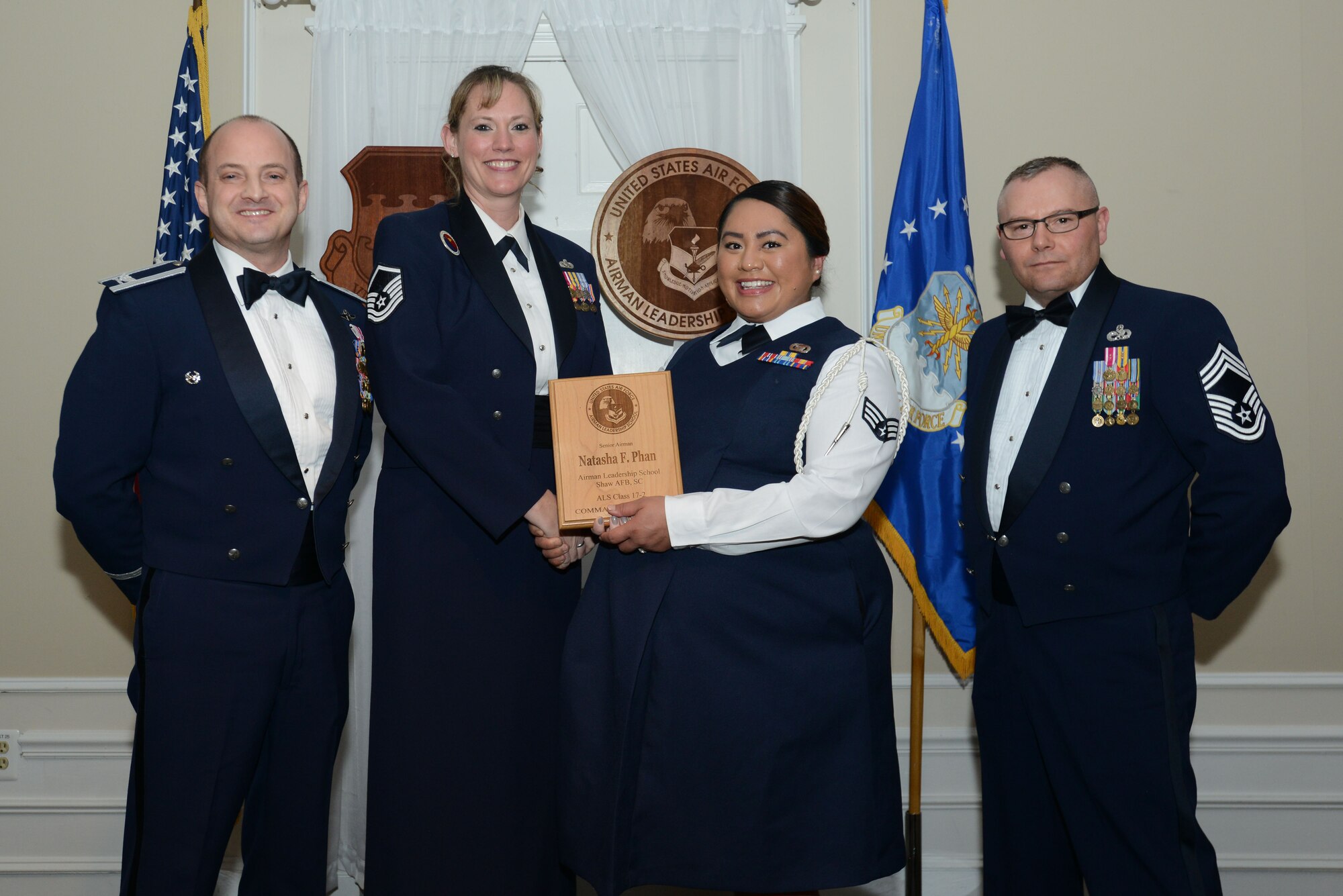 U.S. Air Force Senior Airman Natasha Phan, 5th Intelligence Squadron, receives the Senior Master Sgt. David B. Reid Airman Leadership School Commandant’s Award from Master Sgt. Lindsey Wolf, 20th Force Support Squadron ALS commandant, during the ALS Class 17-2 graduation at Shaw Air Force Base, S.C., Feb. 9, 2017. The Commandant’s Award is presented to the student who most exemplifies professional military qualities as chosen by their peers, the primary instructors and the ALS commandant. (U.S. Air Force photo by Airman 1st Class Kelsey Tucker)