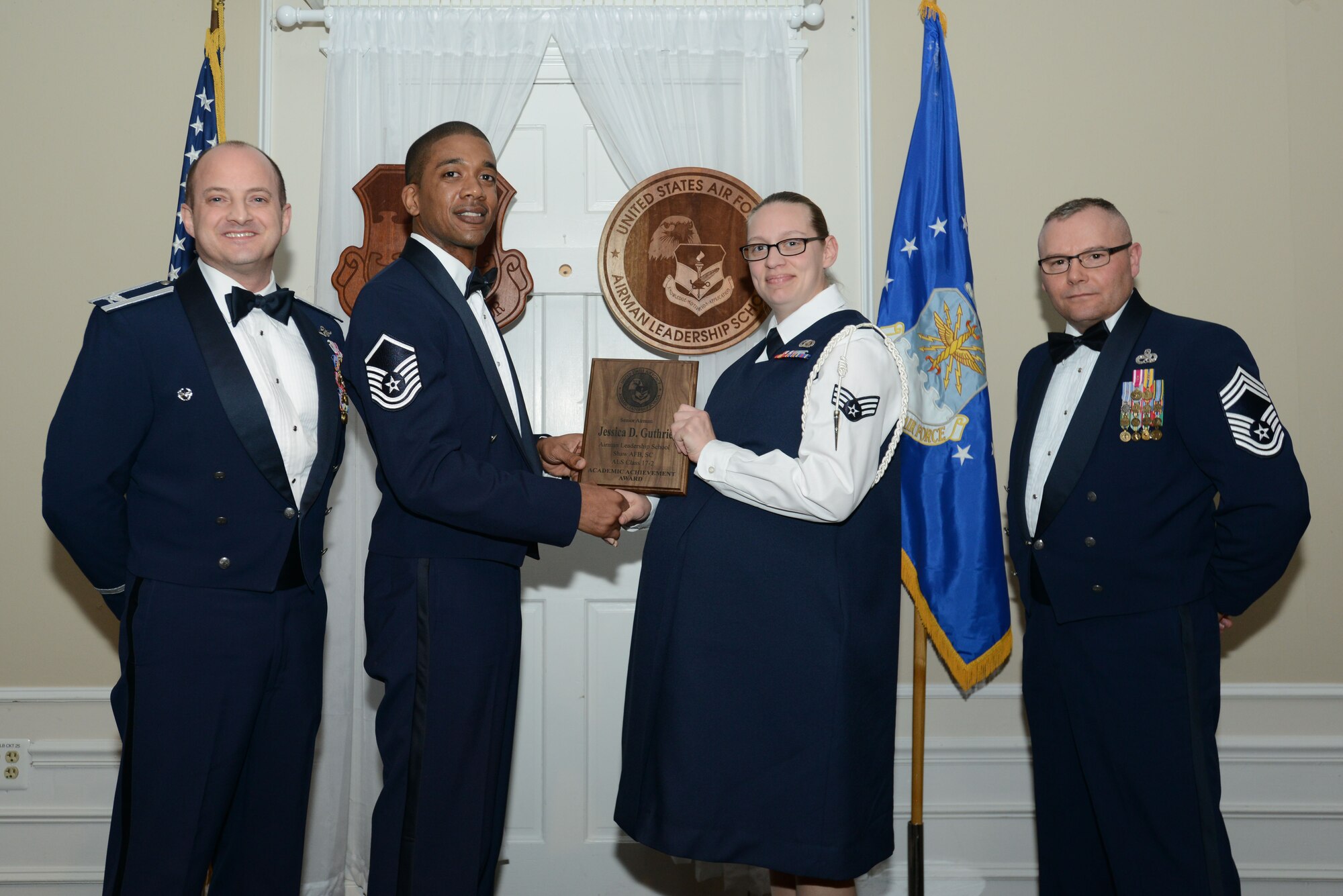 U.S. Air Force Senior Airman Jessica Guthrie, 3rd Intelligence Squadron, receives the Senior Master Sgt. David B. Reid Airman Leadership School Academic Achievement award from Master Sgt. Alvin Edmunds, U.S. Air Forces Central Command aircrew flight equipment air advisor program manager, during the ALS Class 17-2 graduation at Shaw Air Force Base, S.C., Feb. 9, 2017. This award is given to the student with the highest point total. (U.S. Air Force photo by Airman 1st Class Kelsey Tucker)