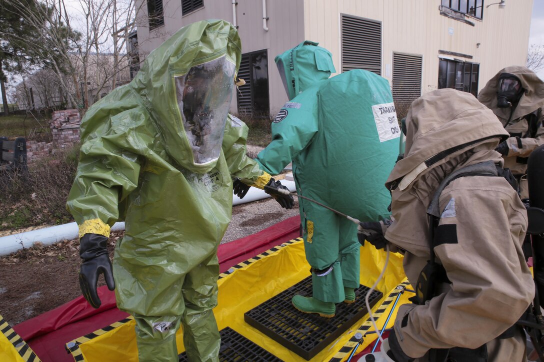 Lance Cpl. Weston Paulson and Lance Cpl. Jonathan White chemical, biological, radiological and nuclear defense specialists with Combat Logistics Regiment 45, 4th Marine Logistics Group, Marine Forces Reserve, undergo a simulated decontamination process during an assessment and consequence management team training exercise at Marine Corps Support Facility, New Orleans, Feb. 8, 2017. During the exercise Marines received reports of a clandestine chemical laboratory. The Marines conducted area reconnaissance, sample collection and classification of unknown present substances. (United States Marine Corps photo by Sgt. Ian Ferro/Published)