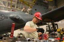 U.S. Air Force Master Sgt. Brent Rose, a repair and reclamation specialist assigned to the 139th Maintenance Squadron, Missouri Air National Guard, wipes down a bolt from a C-130 Hercules aircraft at Rosecrans Air National Guard Base, St. Joseph, Mo., Feb. 7, 2017. Rose was assisting with aircraft maintenance that required the removal of the vertical stabilizer, or tail, of the aircraft. (U.S. Air National Guard photo by Master Sgt. Michael Crane)