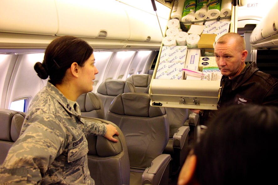 The 932nd C-40C aircraft is toured by a member of the legal staff from active duty on February 14, 2017, at Scott Air Force Base, Ill.. At left, Capt. Natalia Escobar, an active duty lawyer from Air Mobility Command, speaks with Air Force Reserve Command flight attendant, Tech. Sgt. Phillip Robbins, about the special overhead supply storage compartment and his many duties taking care of distinguished visitor mission customers as they travel worldwide.  (U.S. Air Force photo by Lt. Col. Stan Paregien)