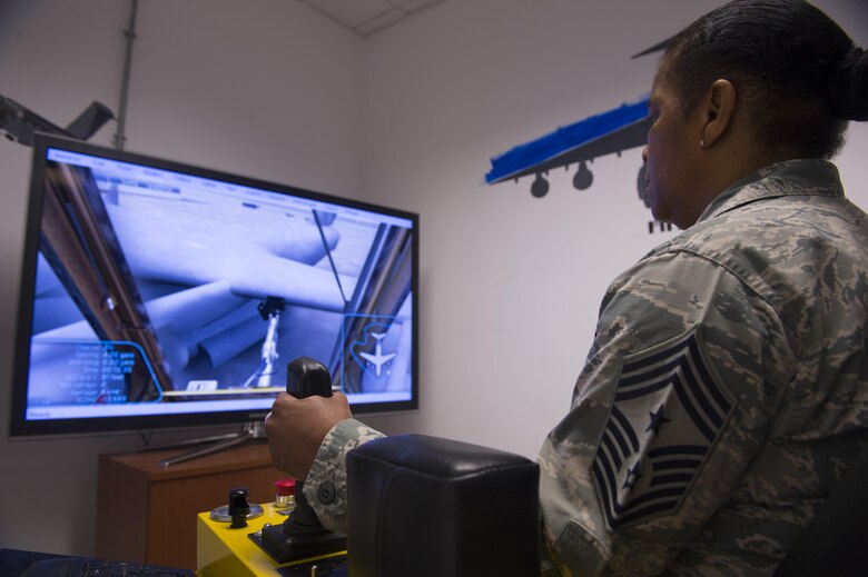 Chief Master Sgt. Shelina Frey, Air Mobility Command command chief, tests out the de-icing simulator at the 726th Air Mobility Squadron at Spangdahlem Air Base, Germany, Feb. 13, 2017. The simulator allows the user to de-ice and anti-ice different types of aircraft under a wide range of weather conditions. Frey visited with AMC Airmen stationed at both Ramstein Air Base and Spangdahlem Air Base, Germany during her visit. The 726th Air Mobility Squadron provides air transportation, cargo, maintenance and enroute support to Allied and American forces.  (U.S. Air Force photo by Senior Airman Dawn M. Weber)