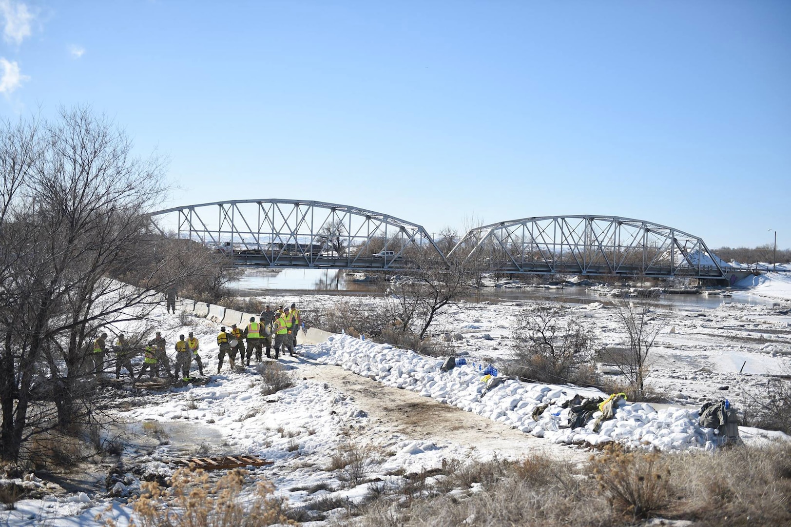 A team of Wyoming National Guard members works to position sandbags to stave off flooding near Worland, Wyo., on Feb. 12, 2017.