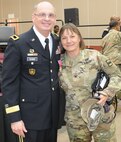Brig. Gen. Thomas P. Evans, deputy commanding general of the 80th Training Command, shares a goodbye hug with Col. Susie S. Kuilan, chief of staff of the 80th TC, at Evans' retirement ceremony at the Defense Supply Center in Richmond, Virginia, Feb. 11, 2017. (Photo by Master Sgt. Stacey Everett, 80th Training Command Headquarters and Headquarters Company)