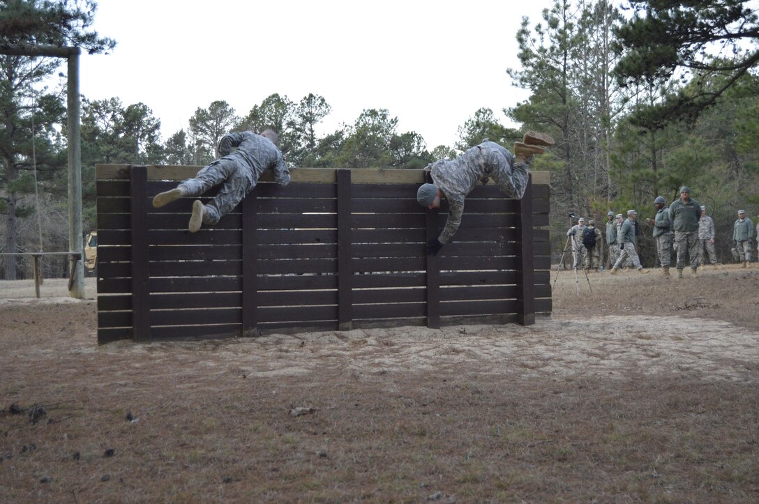 Participants in the 4th ESC Best Warrior Competition navigate a wall obstacle as a part of the events obstacle course.  The 4th ESC held its 2017 Best Warrior Competition at Camp Parks, AR, Feb. 3-5, 2017.  (U.S. Army Reserve photo by Army Master Sgt. Dave Thompson)