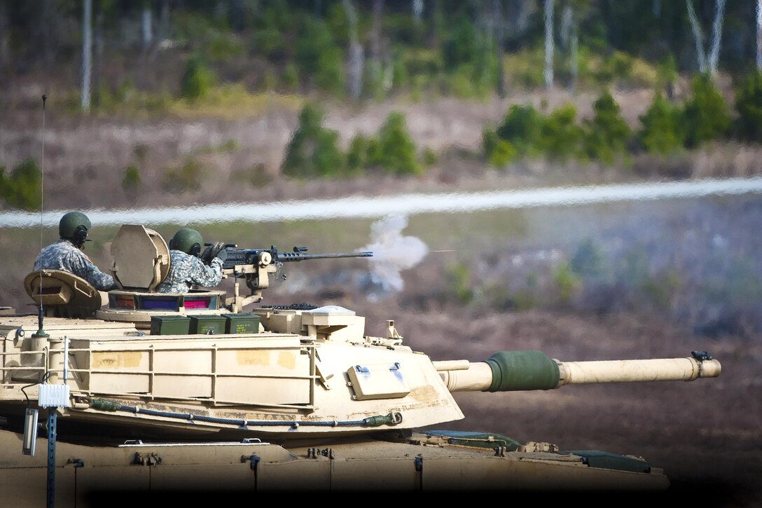 An Army armor basic officer fires a .50-caliber machine gun mounted atop an Abrams tank during live-fire training at Fort Benning, Ga., Feb. 9, 2017. Army photo by Patrick A. Albright