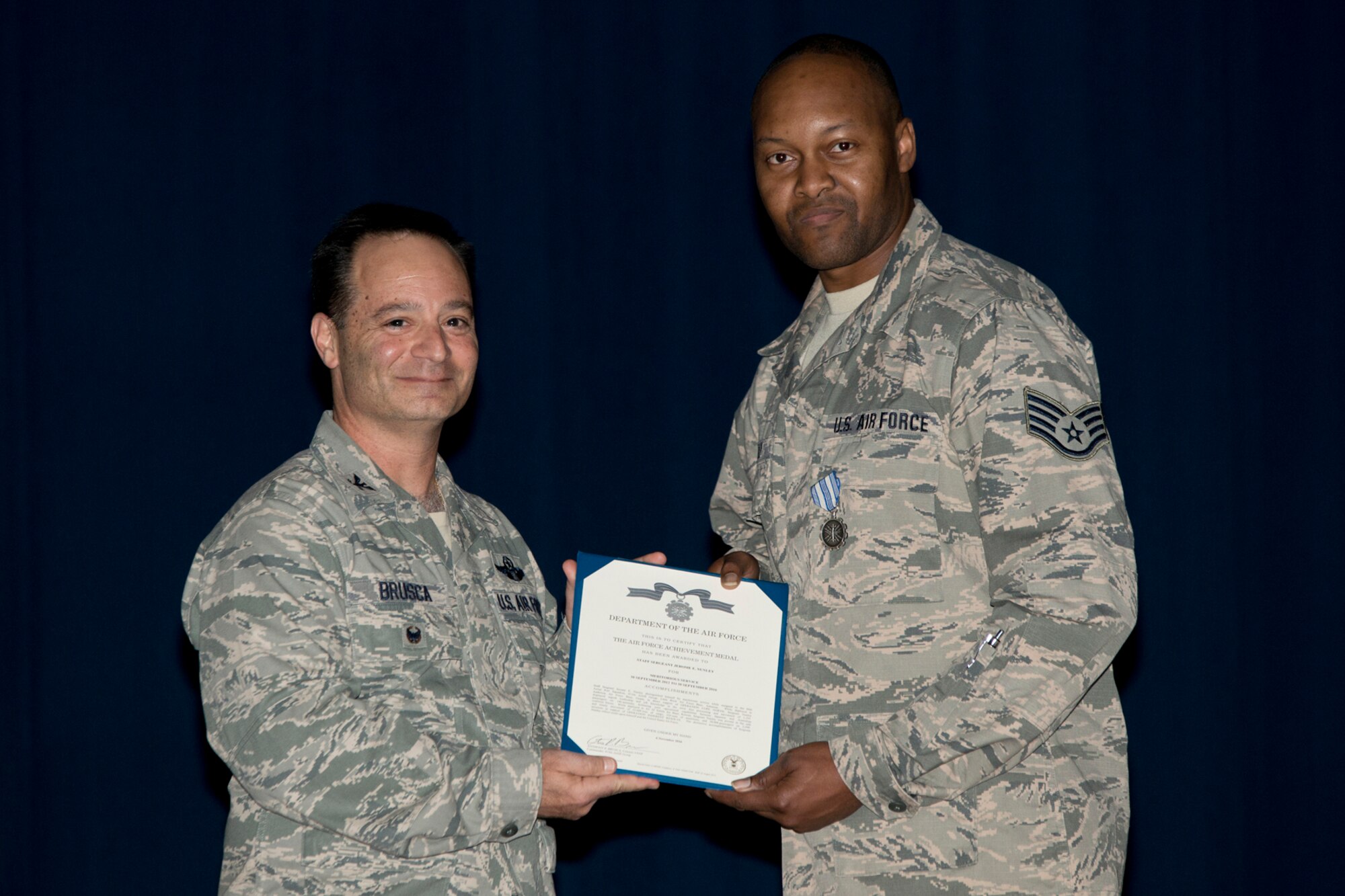 U.S. Air Force Reserve Col. Anthony Brusca, interim commander for the 913th Airlift Group and Staff Sgt. Jerome Nunley, 96th Aerial Port Squadron, pose for a photo during the Group Commander’s Call Feb. 12, 2017, at Little Rock Air Force Base, Ark. Nunley was awarded the Air Force Achievement Medal for meritorious service from 30 September 2012 to 30 September 2016. (U.S. Air Force photo by Master Sgt. Jeff Walston/Released)
