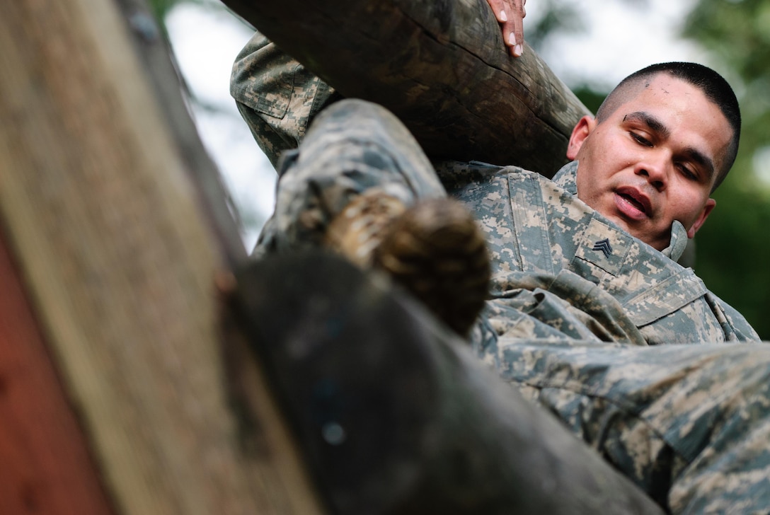 Sgt. Roberto J. Cruz of the 315th Engineer Battalion navigates the reverse climb portion of the confidence course at the 301st Maneuver Enhancement Brigade Best Warrior competition, at Joint-Base Lewis-McChord, Washington, February 9, 2017. Best Warrior is an annual competition designed to test each soldier’s physical and mental fitness, proficiency in warrior tasks, resiliency, and their determination to be the best (U.S. Army Reserve Photo by Spc. Sean Harding/Released).