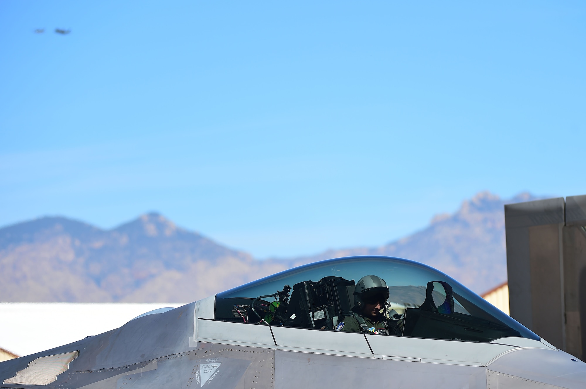 U.S. Air Force Maj. Dan Dickinson, F-22 Raptor Demonstration Team pilot, prepares for flight during the 2017 Heritage Flight Training and Certification Course Davis-Monthan Air Force Base, Ariz., Feb. 10, 2017. Dickinson is the only certified F-22 Raptor Demonstration Team pilot, who is part of the 12-man team that performs all over the world. (U.S. Air Force photo by Senior Airman Kimberly Nagle)