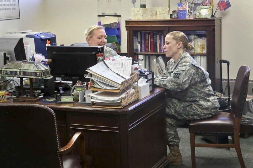 Army Sgt. 1st Class Deborah Hartman of the 318th Press Camp Headquarters speaks with Army Staff Sgt. Carrie Castillo during her last day as the unit administrator during the 318th battle assembly weekend, Forest Park, Ill., February 11, 2017. (U.S Army photo by Sgt. Alfonso Corral)