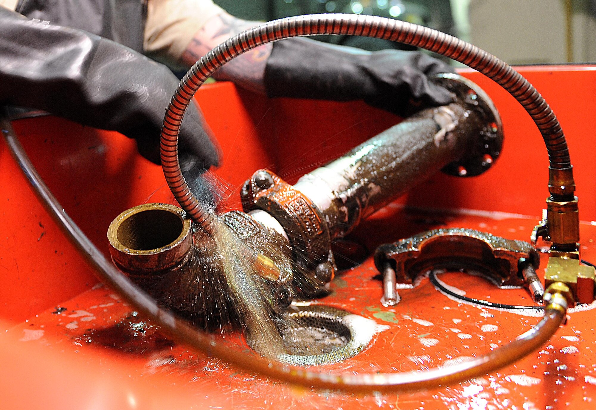 Senior Airman Broderick Laflen, 5th Logistics Readiness Squadron fire truck and refueling mechanic, washes a part from a C301 refueling truck at Minot Air Force Base, N.D., Feb. 8, 2017. The 5th LRS team performs scheduled, unscheduled and preventative maintenance so base operations can continue to run smoothly. (U.S. Air Force photo/Senior Airman Kristoffer Kaubisch)