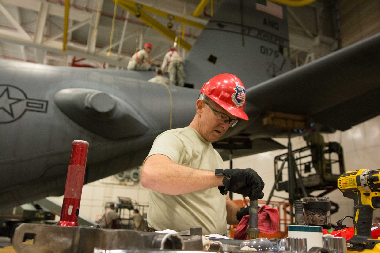 U.S. Air Force Master Sgt. Brent Rose, a repair and reclamation specialist assigned to the 139th Maintenance Squadron, Missouri Air National Guard, wipes down a bolt from a C-130 Hercules aircraft at Rosecrans Air National Guard Base, St. Joseph, Mo., Feb. 7, 2017. Rose was assisting with aircraft maintenance that required the removal of the vertical stabilizer, or tail, of the aircraft. 