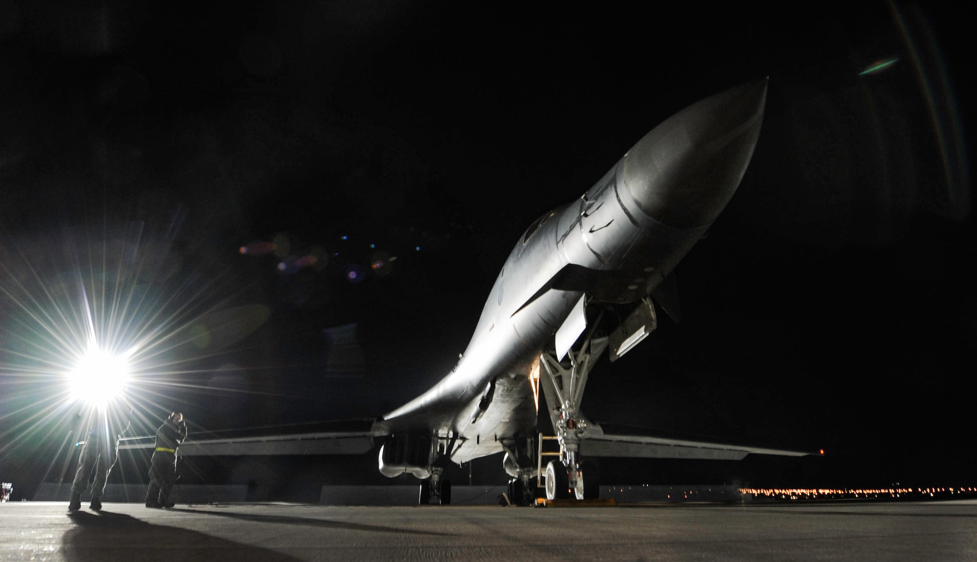 A B-1B Lancer assigned to the 34th Bomb Squadron, Ellsworth Air Force Base, S.D., rests on the flightline as maintainers perform preflight checks during night operations of Red Flag 17-1 on Nellis Air Force Base, Jan. 25, 2017. Flying units from around the globe deploy to Nellis AFB to participate in Red Flag. (U.S. Air Force photo by Airman 1st Class Kevin Tanenbaum/Released)