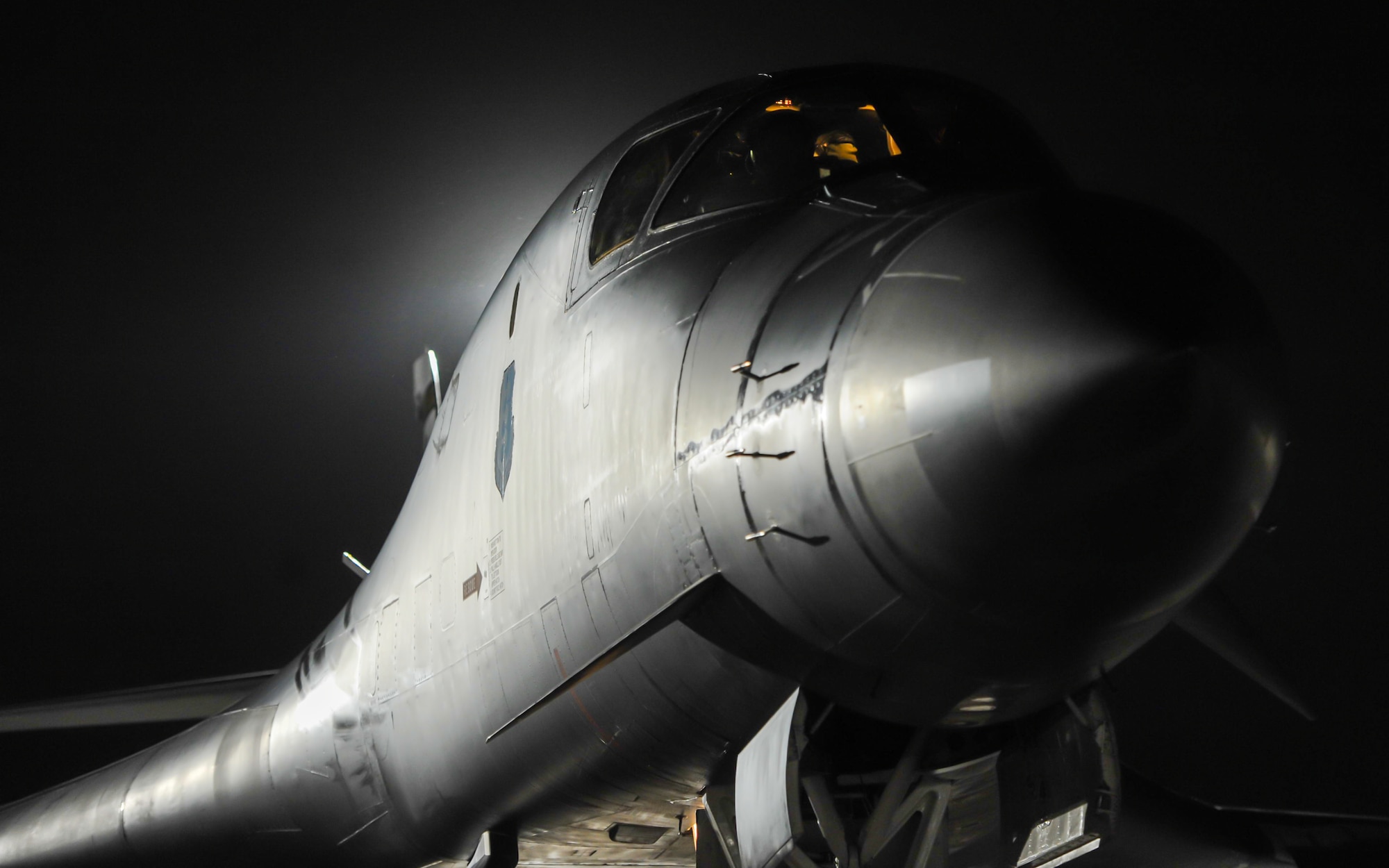 A B-1B Lancer assigned to the 34th Bomber Squadron, Ellsworth Air Force Base, S.D., rests on the flightline as pilots perform preflight checks during Red Flag 17-1 on Nellis Air Force Base, Nev., Jan. 25, 2017. Red Flag night missions present the additional challenge of low visibility, testing aircrew’s ability to execute the mission at any hour in a contested and degraded environment. (U.S. Air Force photo by Airman 1st Class Kevin Tanenbaum/Released)