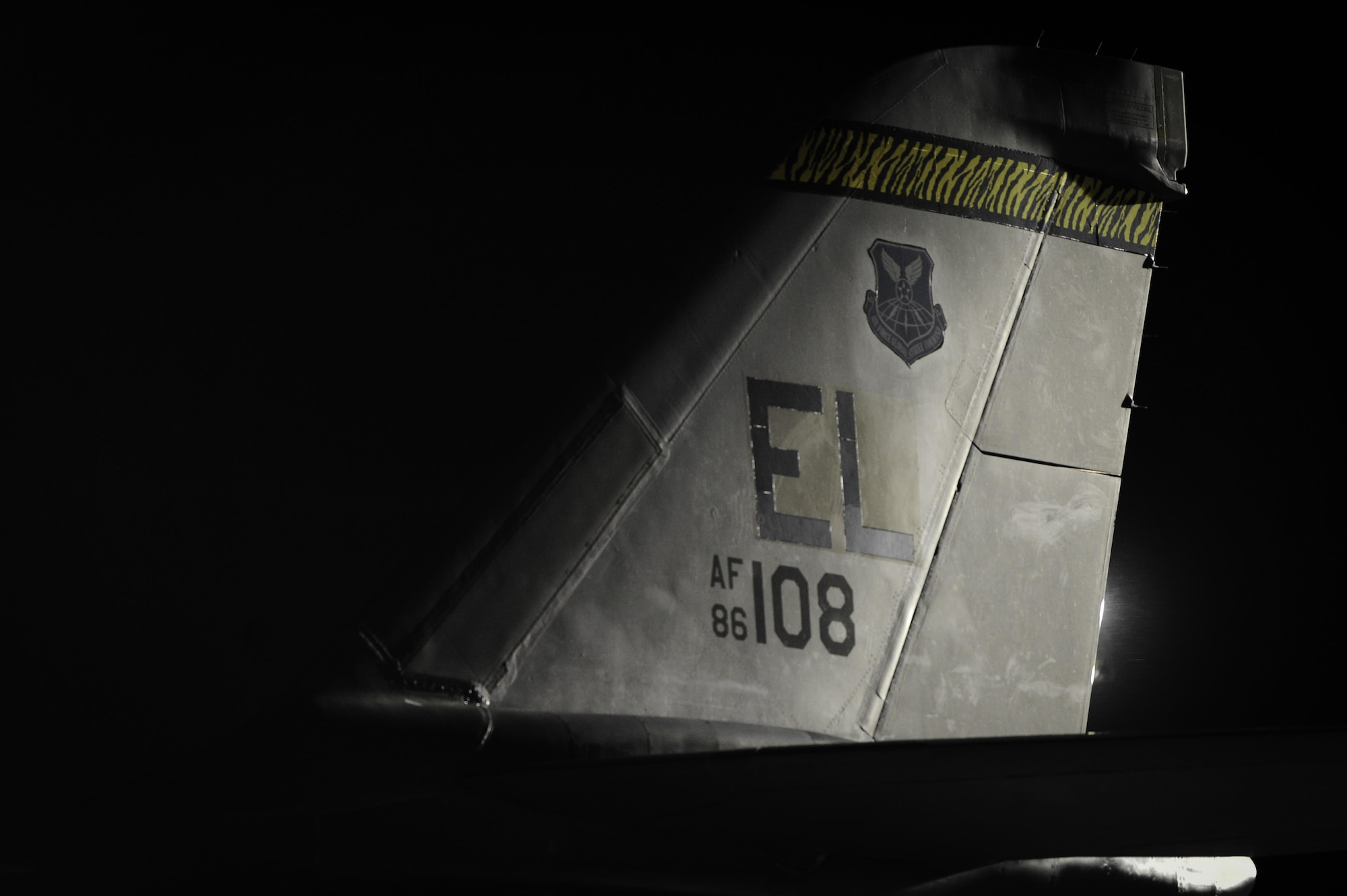 The tail of a B-1B Lancer assigned to the 34th Bomb Squadron, Ellsworth Air Force Base, S.D., rests on the flightline during Red Flag 17-1 on Nellis Air Force Base, Nev., Jan. 25, 2017. Red Flag enhances the 34th BS’s aircrews’ combat readiness and survivability by challenging them with realistic combat scenarios. (U.S. Air Force photo by Airman 1st Class Kevin Tanenbaum/Released)